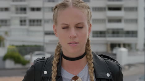 portrait-attractive-young-blonde-woman-looking-serious-independent-caucasian-female-enjoying-sunny-urban-day-in-city-wearing-stylish-leather-jacket-slow-motion