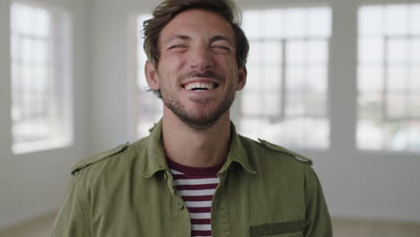 close-up-portrait-of-attractive-young-man-laughing-cheerful-enjoying-lifestyle-happy-caucasian-guy-in-apartment-background