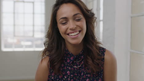slow-motion-portrait-of-attractive-young-hispanic-woman-laughing-cheerful-looking-at-camera-wearing-beautiful-floral-blouse-in-apartment-background
