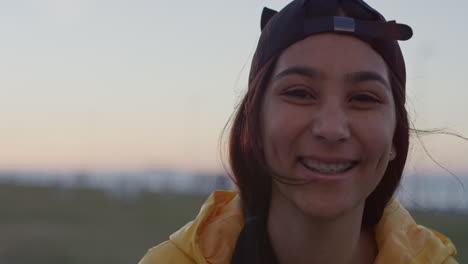 close-up-portrait-of-teenage-girl-laughing-cheerful-looking-at-camera-wearing-braces-enjoying-park-at-sunset-slow-motion
