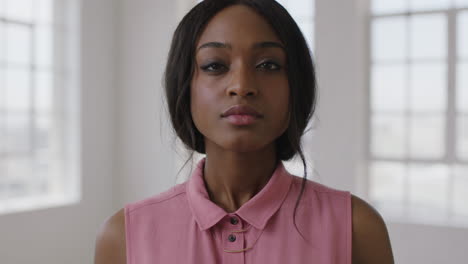 close-up-slow-motion-portrait-of-young-stylish-african-american-woman-looking-serious-intense-at-camera-wearing-pink-blouse