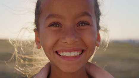 close-up-portrait-young-happy-mixed-race-girl-smiling-enjoying-summer-vacation-on-beautiful-park-at-sunset-real-people-series