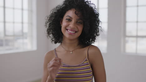 attractive-mixed-race-woman-portrait-of-pretty-hispanic-girl-laughing-happy-looking-at-camera-cheerful-afro-hairstyle-in-apartment-windows-background