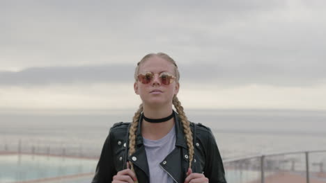 portrait-of-beautiful-blonde-woman-wearing-sunglasses-and-leather-jacket-waiting