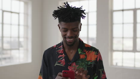 portrait-of-relaxed-african-american-man-texting-browsing-social-media-using-smartphone-mobile-technology-smiling-enjoying-digital-communication