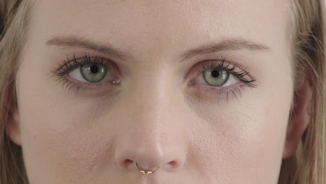 close-up-face-beautiful-blonde-woman-eyes-open-staring-at-camera-wearing-nose-ring