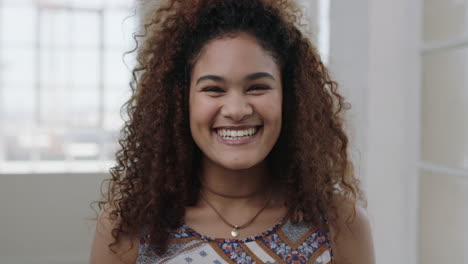 cute-young-woman-portrait-of-pretty-mixed-race-girl-frizzy-hair-making-faces-looking-at-camera-smiling-happy
