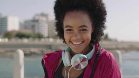 portrait-of-attractive-african-american-woman-in-sportswear-smiling-cheerful-on-beautiful-sunny-beachfront