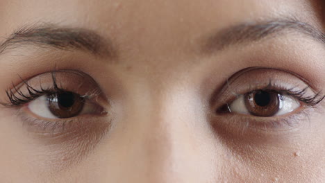 close-up-of-woman-brown-eyes-opening-looking-at-camera-wearing-makeup-cosmetics
