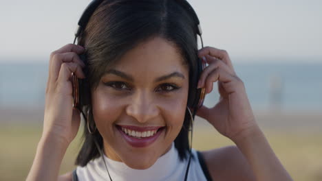 portrait-lively-young-hispanic-woman-takes-off-headphones-enjoying-relaxed-summer-day-listening-to-music-slow-motion