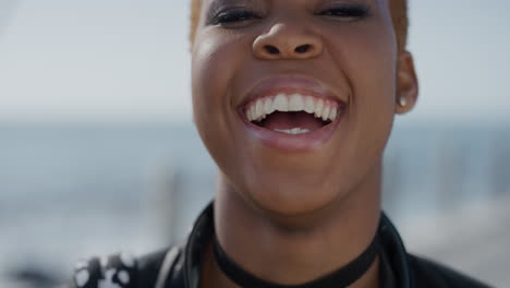 close-up-portrait-successful-young-african-american-woman-laughing-enjoying-independent-lifestyle-stylish-black-female-student-looking-happy-on-seaside-ocean-background-slow-motion