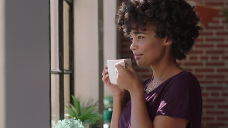 Hermosa-Mujer-Bebiendo-Café-En-Casa-Disfrutando-Del-Aroma-Mirando-Por-La-Ventana-Relajada-Mujer-Afroamericana-Con-Moderno-Peinado-Afro-Sonriendo-Satisfacción