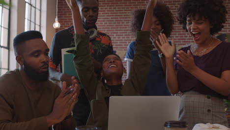 group-of-business-people-celebrating-corporate-success-black-colleagues-laughing-clapping-cheerful-enjoying-successful-victory-watching-laptop-in-modern-office-workplace