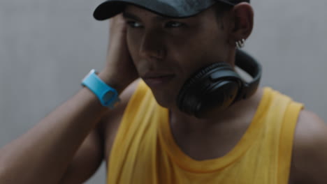 close-up-portrait-young-happy-mixed-race-man-listening-to-music-wearing-headphones-enjoying-relaxing-lifestyle
