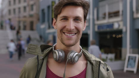 portrait-of-cheerful-attractive-young-man-smiling-confident-at-camera-in-busy-urban-background