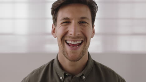 close-up-portrait-of-handsome-young-man-laughing-cheerful-looking-at-camera-enjoying-successful-lifestyle
