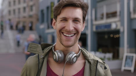 portrait-of-cheerful-attractive-young-man-laughing-happy-at-camera-in-busy-urban-background