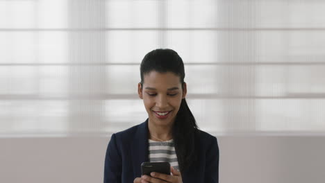 portrait-of-young-mixed-race-business-woman-executive-smiling-happy-texting-browsing-using-smartphone-online-networking-enjoying-mobile-communication