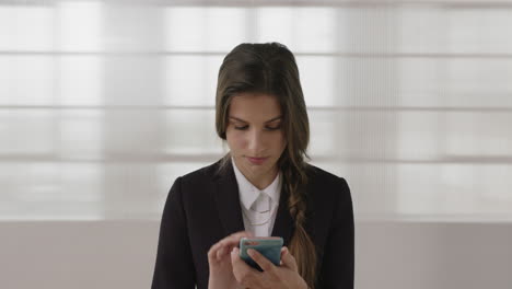 portrait-of-young-caucasian-business-woman-intern-texting-browsing-online-using-smartphone-networking-serious-focused-female
