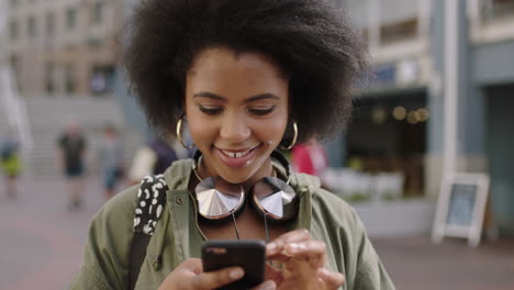 slow-motion-portrait-of-young-trendy-african-american-woman-using-smartphone-app-texting-browsing-social-media-enjoying-urban-lifestyle