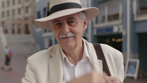 portrait-of-stylish-elderly-man-tourist-smiling-cheerful-enjoying-urban-sightseeing-travel-wearing-white-suit