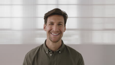 portrait-of-handsome-young-man-laughing-cheerful-looking-at-camera