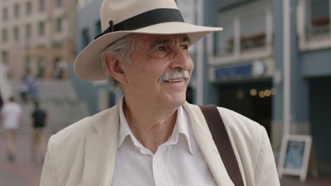 portrait-of-stylish-elderly-man-smiling-enjoying-vacation-sightseeing-wearing-white-suit-and-hat-travel-tourism