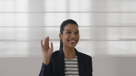 portrait-of-young-independent-mixed-race-business-woman-laughing-cheerful-waving-hand-looking-at-camera