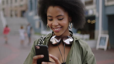 slow-motion-portrait-of-young-trendy-african-american-woman-smiling-cheerful-using-smartphone-taking-photo-enjoying-sightseeing