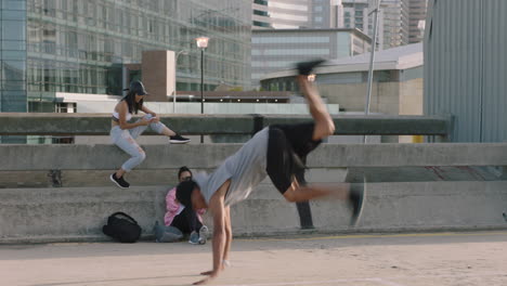 dancing-man-young-mixed-race-street-dancer-man-breakdancing-freestyle-moves-performing-hand-stand-friends-watching-using-smartphone-taking-video-enjoying-dance-in-city