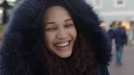close-up-portrait-of-young-beautiful-mixed-race-woman-with-frizzy-hair-laughing-happy-enjoying-cold-urban-evening