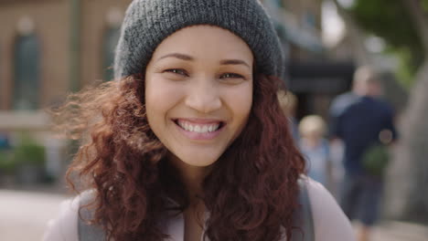 close-up-portrait-of-pretty-mixed-race-girl-smiling-happy-at-camera-wearing-beanie-hat
