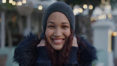 portrait-happy-young-mixed-race-woman-student-smiling-excited-enjoying-playful-fun-in-city-wearing-beanie-hat-slow-motion