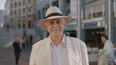 portrait-of-stylish-elderly-man-tourist-smiling-cheerful-enjoying-urban-sightseeing-travel-wearing-white-suit