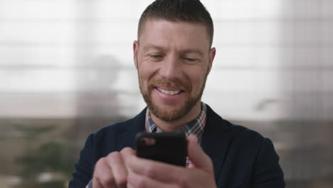 close-up-portrait-of-professional-businessman-texting-browsing-using-smartphone-mobile-networking-technology-checking-messages-in-busy-office-workspace-background