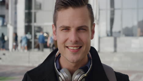 portrait-attractive-young-businessman-takes-off-headphones-smiling-enjoying-successful-urban-lifestyle-in-city-listening-to-music