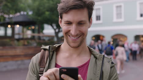 portrait-of-handsome-young-caucasian-man-using-smartphone-browsing-mobile-app-texting--urban-background