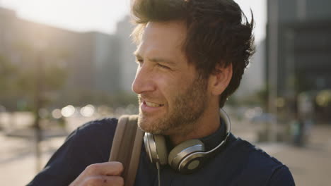 close-up-portrait-of-cool-attractive-caucasian-man-looking-confident-smiling-at-camera-in-city-at-sunset-enjoying-urban-commuting-lifestyle