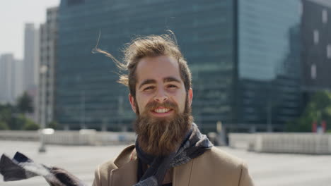portrait-professional-young-hipster-man-smiling-enjoying-successful-urban-lifestyle-happy-bearded-entrepreneur-in-sunny-outdoors-city-slow-motion