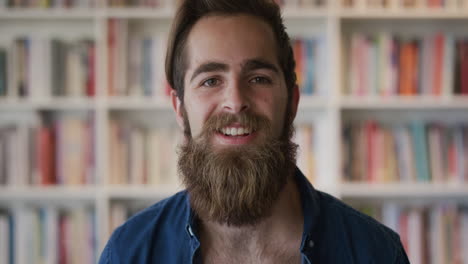 portrait-cute-bearded-hipster-man-student-smiling-enjoying-successful-college-education-lifestyle-happy-entrepreneur-in-bookshelf-background-slow-motion