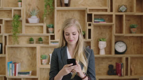 portrait-of-attractive-young-blonde-business-woman-executive-using-smartphone-browsing-networking