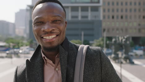 portrait-of-happy-young-african-american-businessman-smiling-cheerful-at-camera-enjoying-sunny-urban-city-commuting