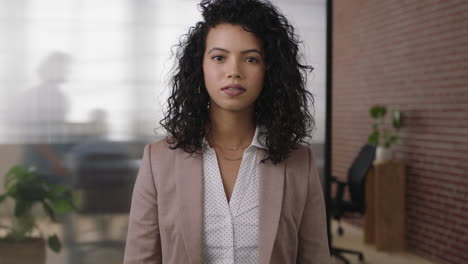 portrait-of-beautiful-stylish-hispanic-business-woman-boss-looking-serious-pensive-at-camera-arms-crossed-in-office-workspace