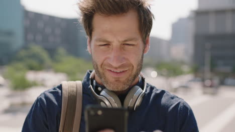 portrait-of-handsome-young-caucasian-man-texting-browsing-using-smartphone-social-media-app-enjoying-mobile-communication-in-sunny-urban-city