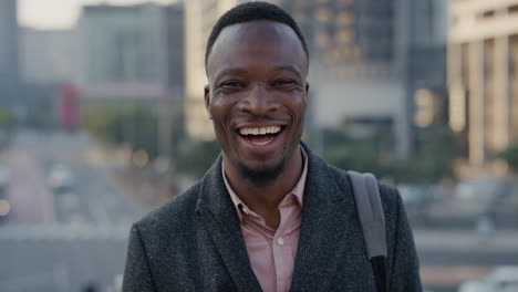 portrait-happy-african-american-businessman-laughing-enjoying-successful-lifestyle-professional-black-entrepreneur-in-city-at-sunset-slow-motion