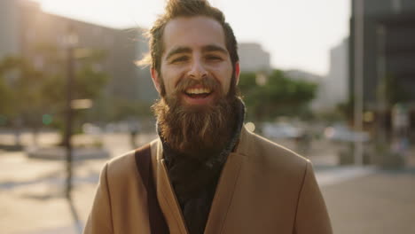 portrait-of-happy-young-bearded-hipster-man-smiling-cheerful-enjoying-city-urban-lifestyle-commuting