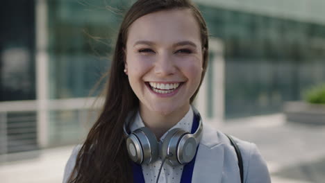 portrait-of-beautiful-young-lively-woman-smiling-at-campus-intern-laughing-office-corporate-outdoors