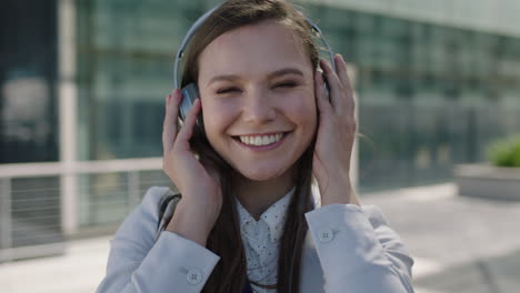 portrait-of-beautiful-young-lively-woman-dancing-to-music-on-headphones-smiling-at-campus-intern-office-corporate-outdoors-fun