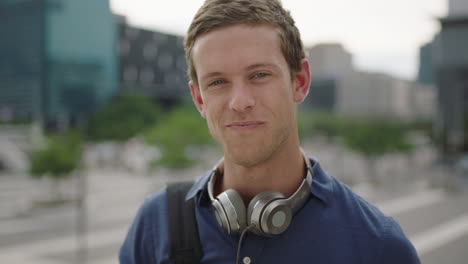 close-up-portrait-of-happy-young-caucasian-man-student-looking-at-camera-laughing-cheerful-on-college-campus-in-city-background-slow-motion