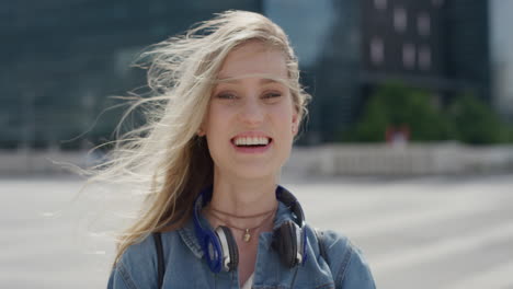 portrait-beautiful-young-blonde-woman-student-laughing-in-city-enjoying-independent-urban-lifestyle-wind-blowing-hair-slow-motion